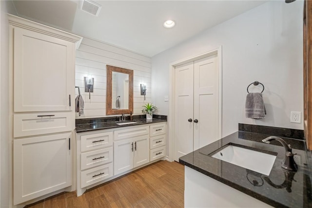 bathroom featuring hardwood / wood-style flooring and vanity