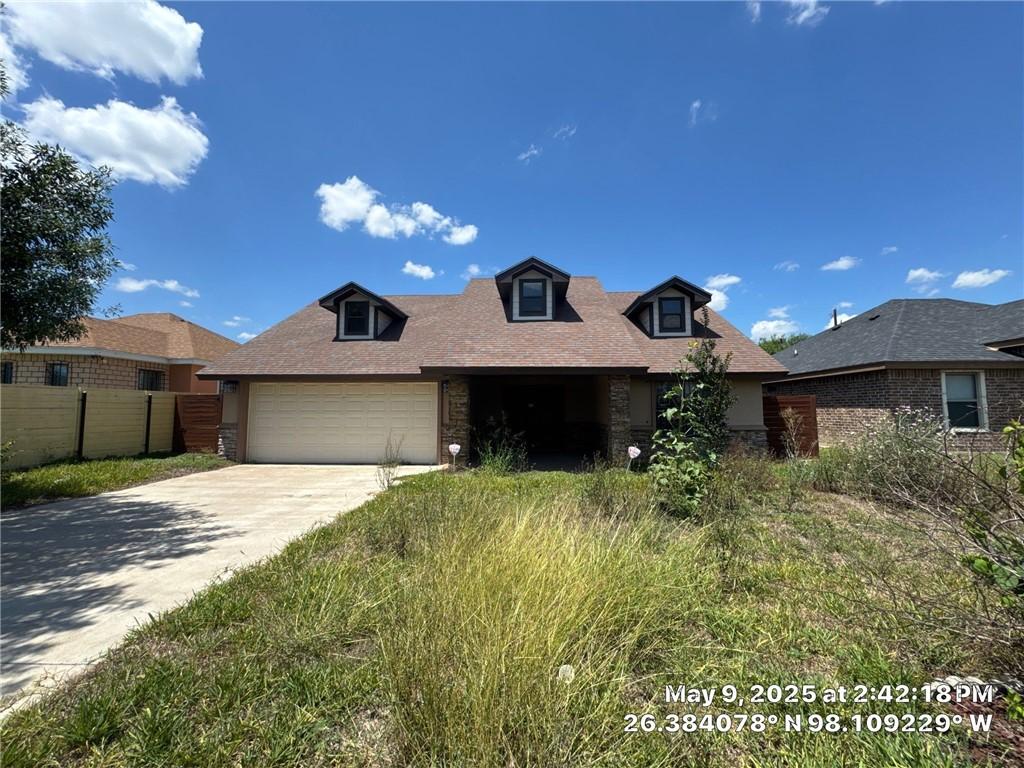 3309 Tulipan Ave, Edinburg, TX 78542 - view of front facade with an attached garage, concrete driveway, and roof with shingles