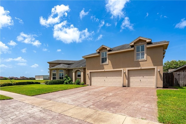 view of front of property with a garage and a front yard