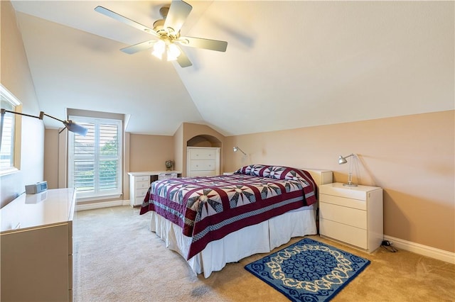 bedroom featuring vaulted ceiling, light carpet, and ceiling fan