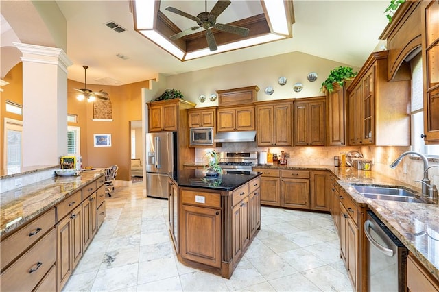 kitchen with ceiling fan, appliances with stainless steel finishes, sink, and dark stone countertops