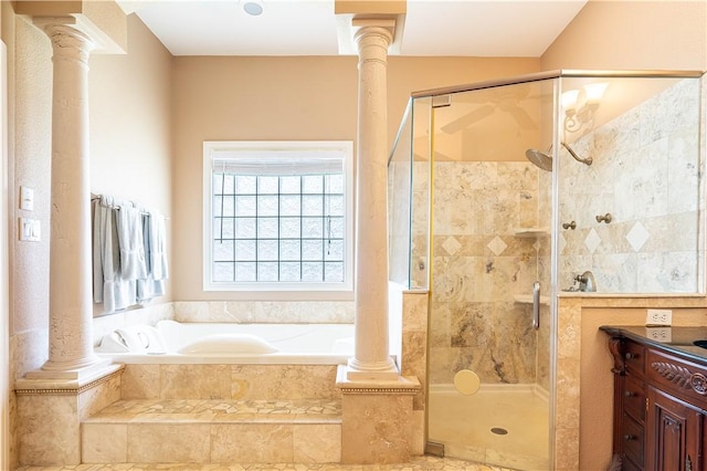 bathroom with ornate columns, shower with separate bathtub, and vanity