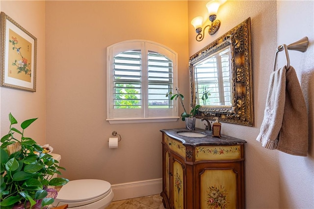 bathroom featuring tile patterned flooring, vanity, a wealth of natural light, and toilet