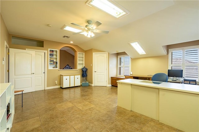 unfurnished office with vaulted ceiling, ceiling fan, and light tile patterned flooring