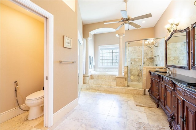 full bathroom featuring decorative columns, independent shower and bath, vanity, ceiling fan, and toilet