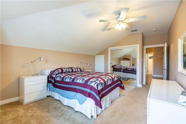 carpeted bedroom featuring ceiling fan, vaulted ceiling, and a closet