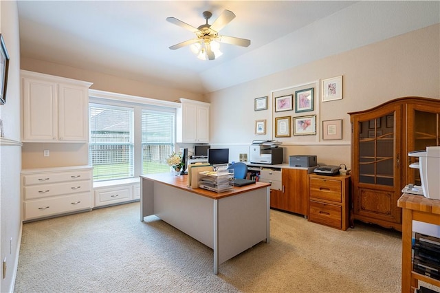 office area featuring lofted ceiling, light carpet, and ceiling fan