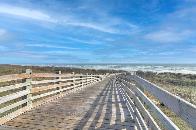 view of property's community with a beach view and a water view