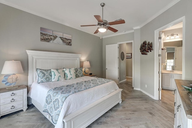 bedroom with ceiling fan, connected bathroom, baseboards, and ornamental molding