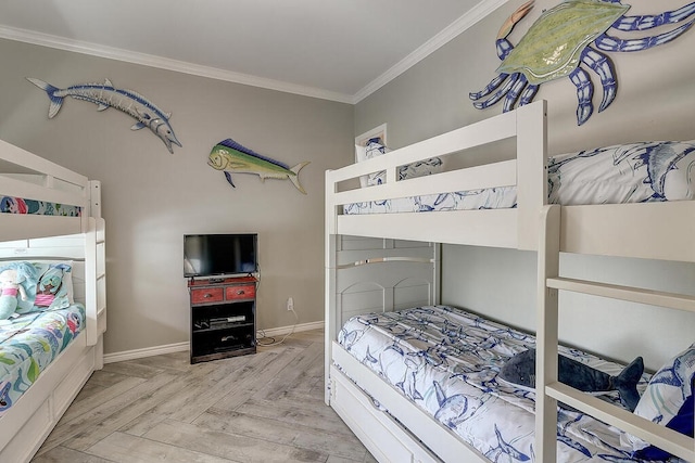 bedroom with parquet flooring, baseboards, and ornamental molding