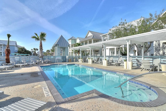 pool with a patio and fence