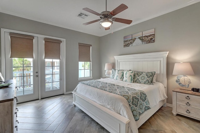 bedroom featuring wood finished floors, visible vents, ornamental molding, access to exterior, and french doors