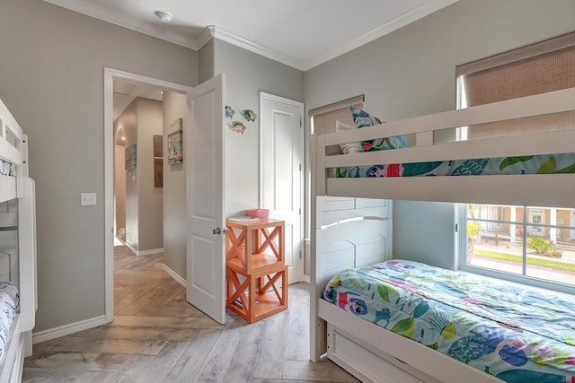 bedroom featuring crown molding and baseboards