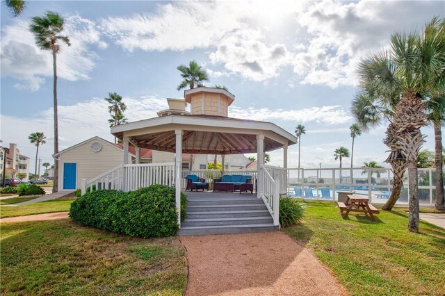 view of property's community featuring a yard, a gazebo, and a swimming pool