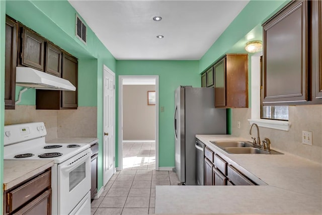 2826 Toronto Dr, Corpus Christi, TX 78414 - kitchen with electric range, a sink, under cabinet range hood, dishwasher, and light countertops