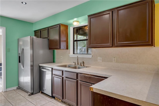 2826 Toronto Dr, Corpus Christi, TX 78414 - kitchen with stainless steel appliances, a sink, light countertops, light tile patterned floors, and baseboards
