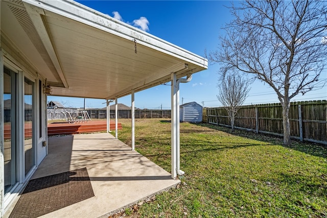 view of yard featuring a patio area and a wooden deck