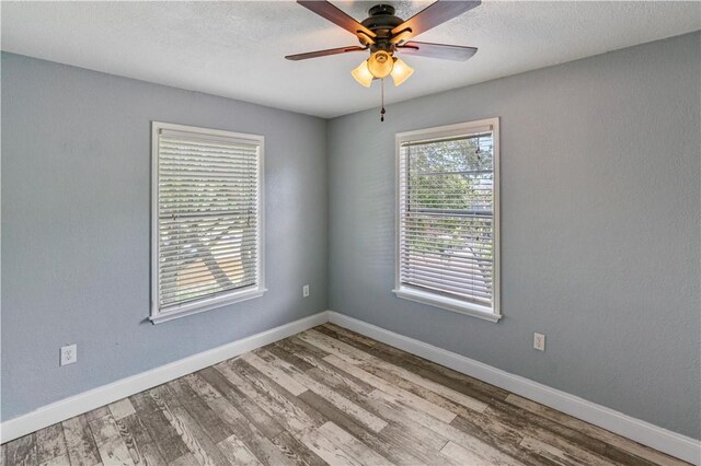 266 Lola Johnson Rd, Corpus Christi, TX 78418 - spare room with wood finished floors, ceiling fan, baseboards, and a textured ceiling