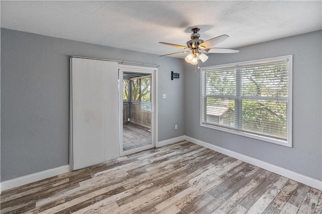 266 Lola Johnson Rd, Corpus Christi, TX 78418 - empty room featuring wood finished floors, a ceiling fan, baseboards, and a textured wall