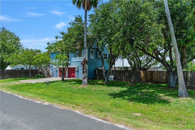 266 Lola Johnson Rd, Corpus Christi, TX 78418 - view of front facade featuring stairs, driveway, and an attached garage