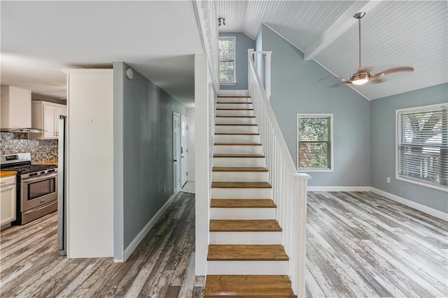 266 Lola Johnson Rd, Corpus Christi, TX 78418 - staircase featuring wood finished floors, healthy amount of natural light, baseboards, ceiling fan, and high vaulted ceiling