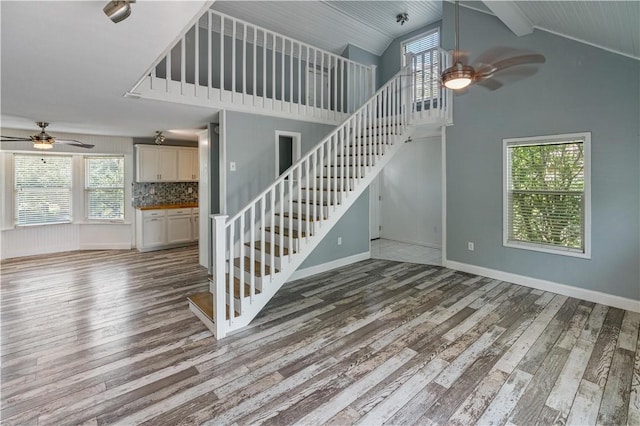 266 Lola Johnson Rd, Corpus Christi, TX 78418 - stairway featuring ceiling fan, wood-type flooring, high vaulted ceiling, and baseboards