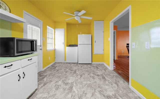 kitchen featuring white cabinets, washer / dryer, white refrigerator, and ceiling fan