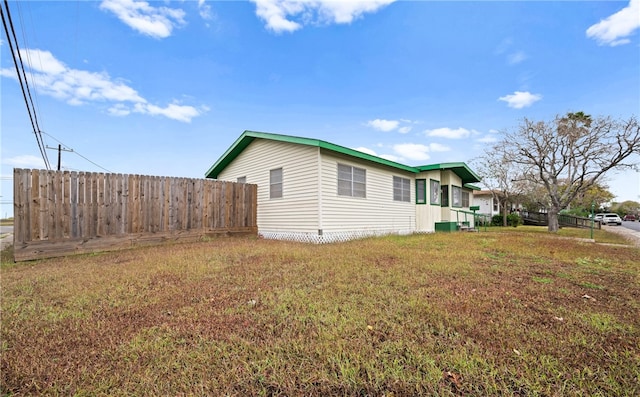 view of side of property featuring a yard