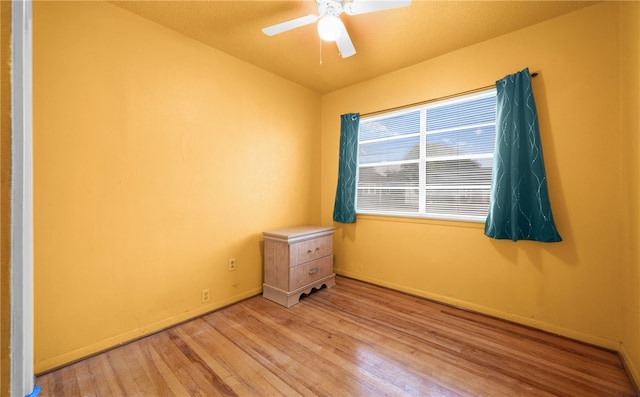 unfurnished bedroom with ceiling fan and light wood-type flooring