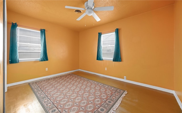 spare room featuring a textured ceiling and ceiling fan