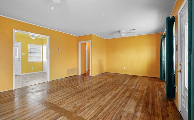 unfurnished room with ceiling fan and wood-type flooring