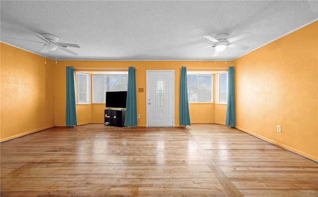 unfurnished living room with a textured ceiling, light hardwood / wood-style flooring, and ceiling fan