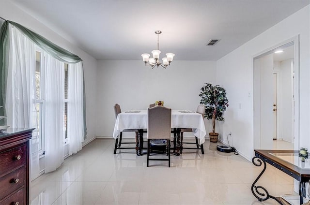 dining space featuring a chandelier, light tile patterned floors, visible vents, and baseboards