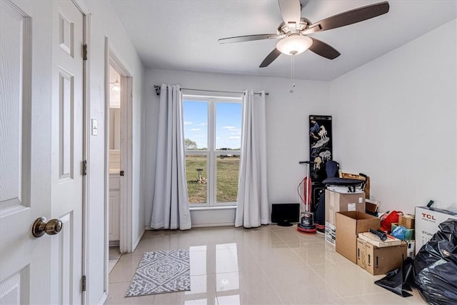 interior space with tile patterned flooring and ceiling fan