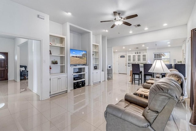 living room with built in features, ceiling fan, visible vents, recessed lighting, and baseboards