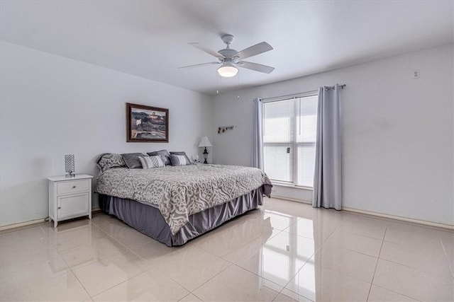 bedroom with light tile patterned floors, baseboards, and a ceiling fan