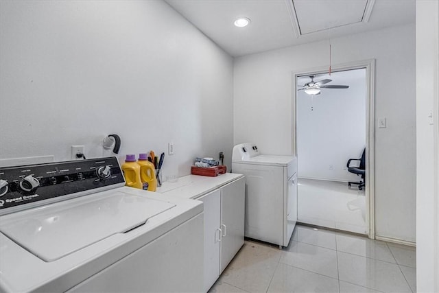 washroom with light tile patterned floors, separate washer and dryer, a ceiling fan, attic access, and cabinet space