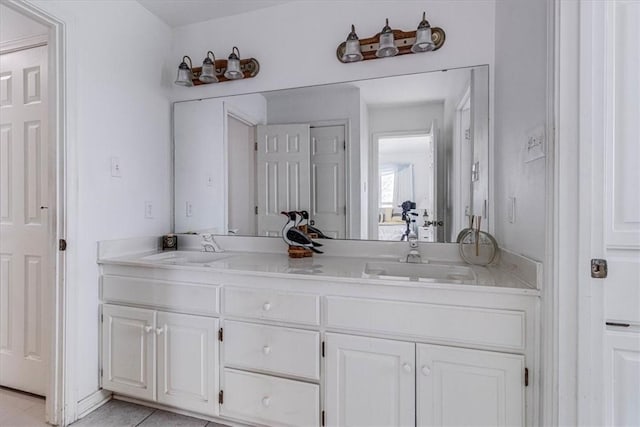 full bathroom with a sink, double vanity, and tile patterned flooring
