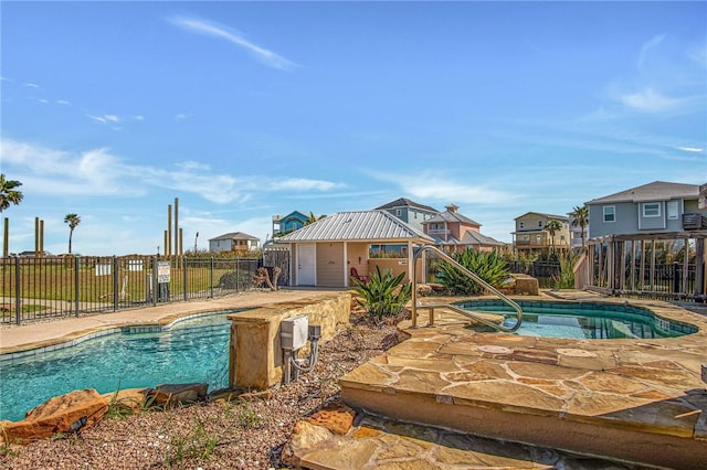 view of swimming pool featuring an in ground hot tub