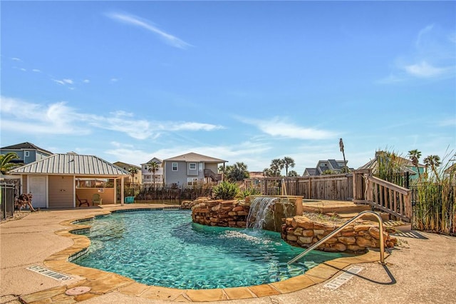 view of pool with pool water feature, a patio area, and a gazebo