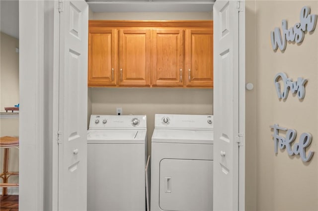 laundry area with cabinets and washing machine and dryer