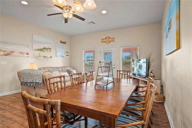 dining area with ceiling fan and dark hardwood / wood-style flooring