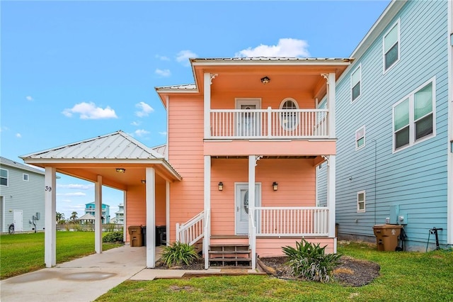 view of front of house featuring a balcony, a front yard, a porch, and a carport