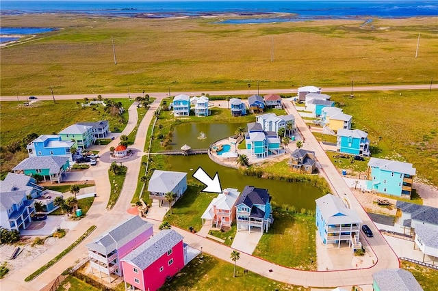 birds eye view of property with a water view and a rural view