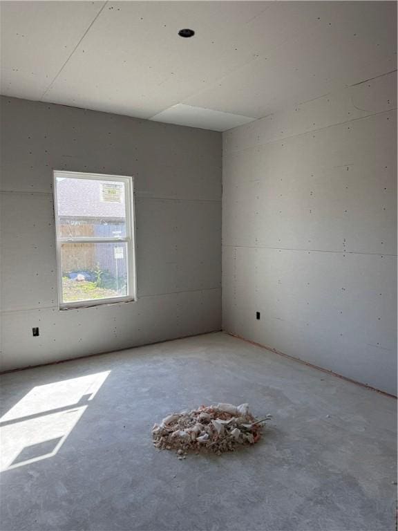 empty room featuring unfinished concrete floors