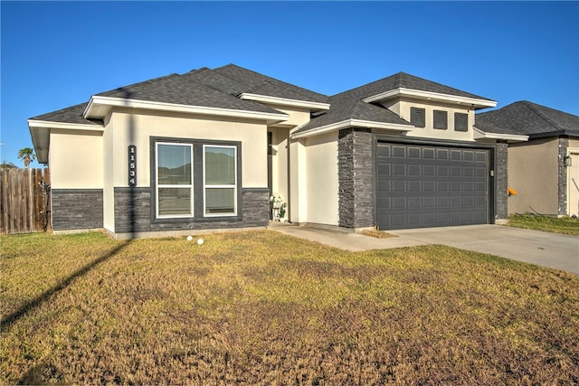 prairie-style home featuring a garage and a front lawn