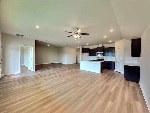 3405 Tanzanite Dr, Corpus Christi, TX 78414 - kitchen with appliances with stainless steel finishes, open floor plan, a center island with sink, ceiling fan, and light wood-style flooring