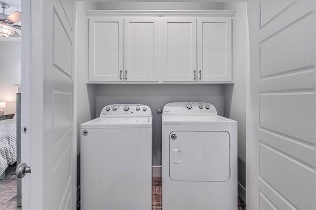 clothes washing area with cabinet space and separate washer and dryer