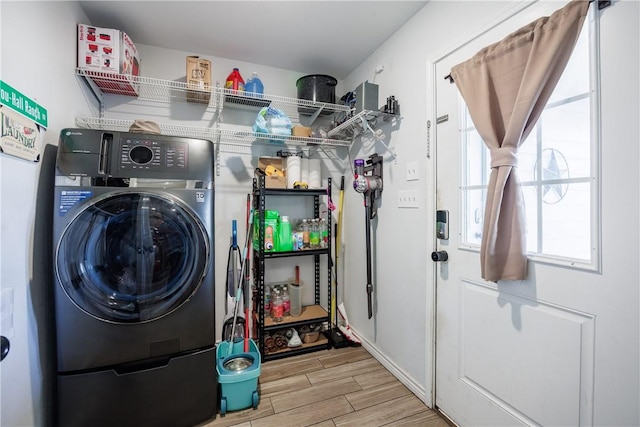 laundry room featuring washer / dryer, wood tiled floor, and laundry area