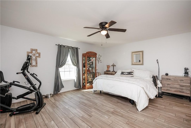 bedroom featuring light wood-type flooring and a ceiling fan